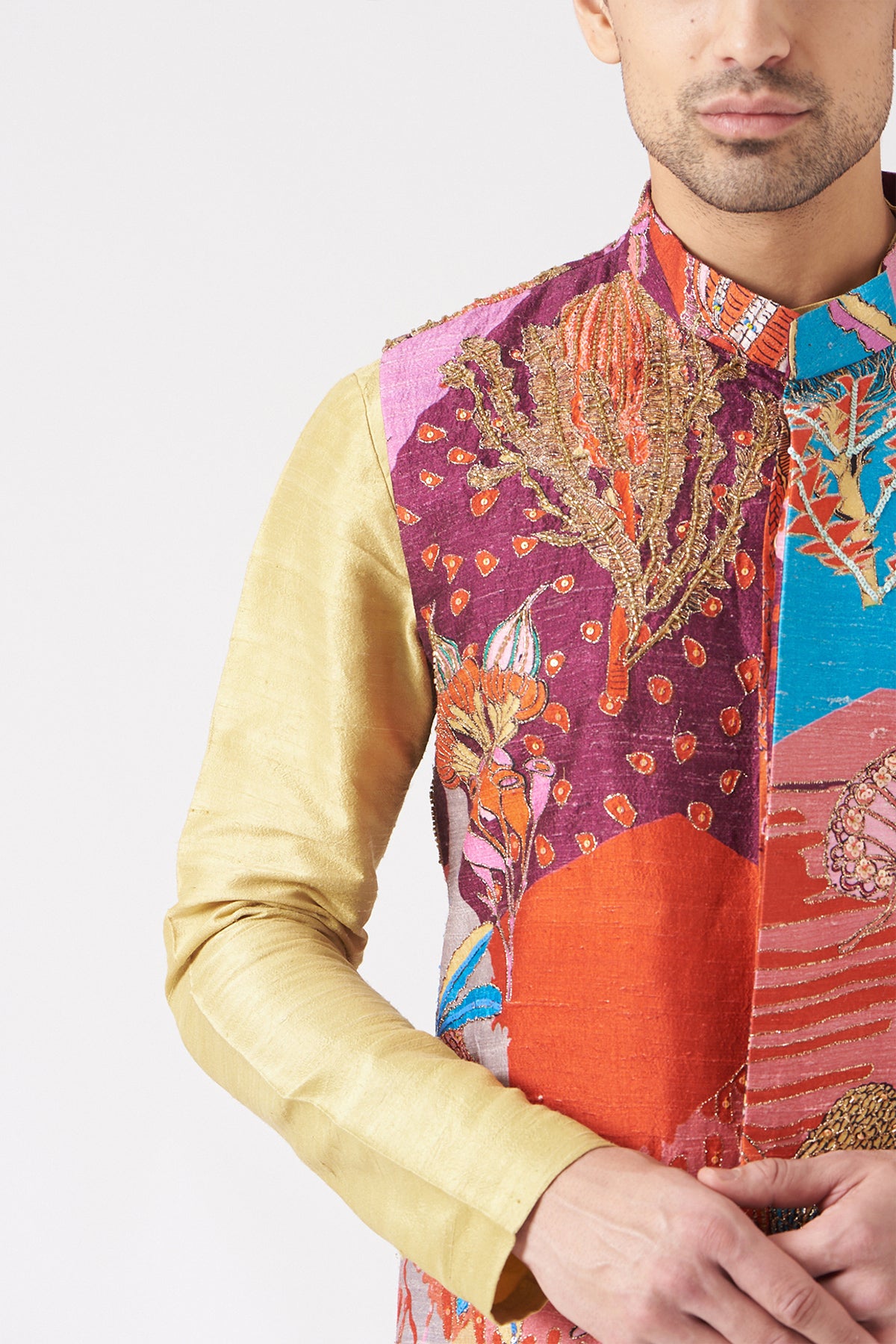 Close-up of front print and embellishments on plum bundi and kurta