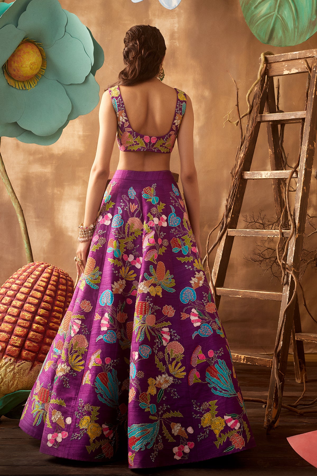Back view of purple pastiche raw silk appliquéd lehenga with blouse and cutwork dupatta