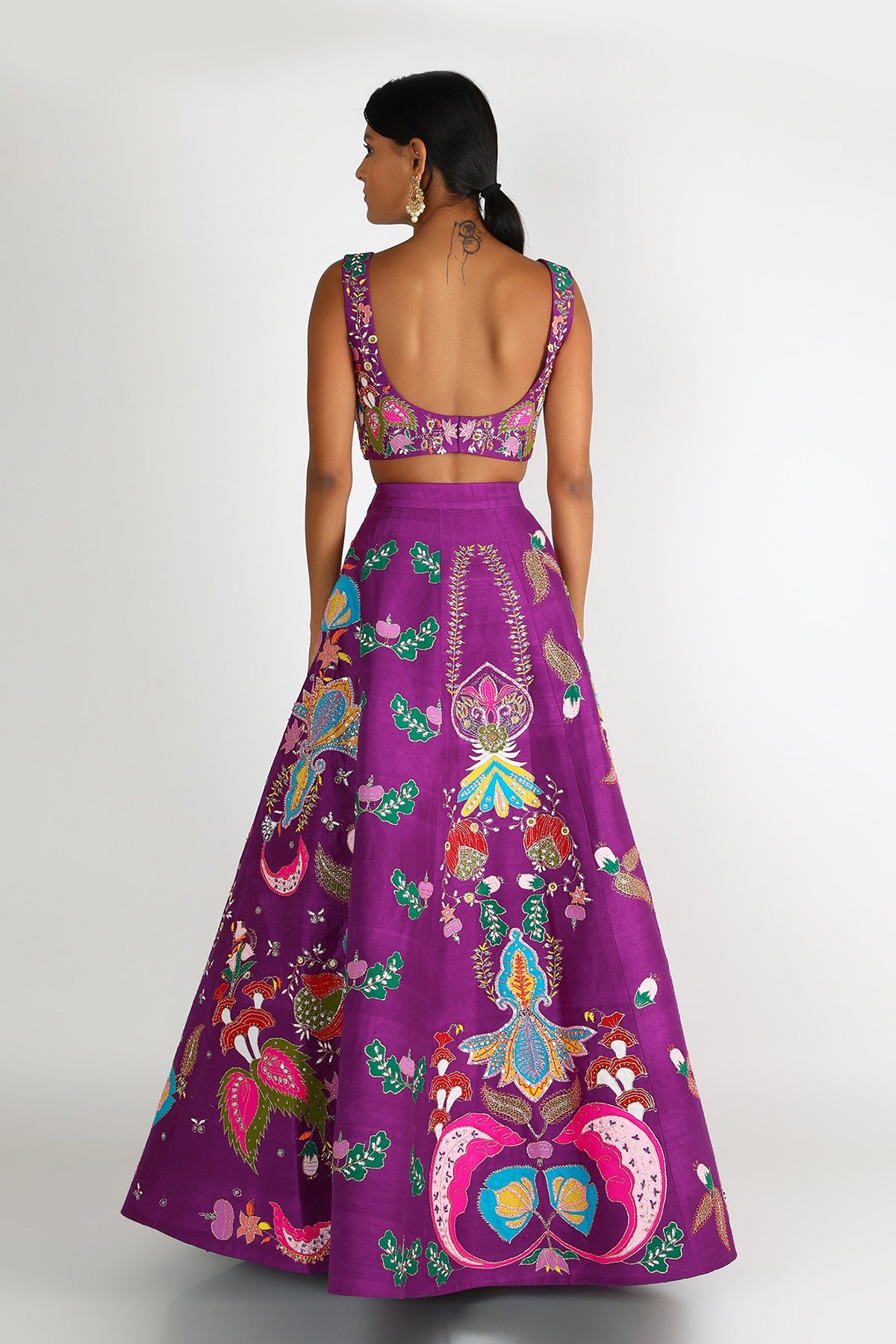 Back view of violet nadenka raw silk appliquéd lehenga with blouse and cutwork dupatta