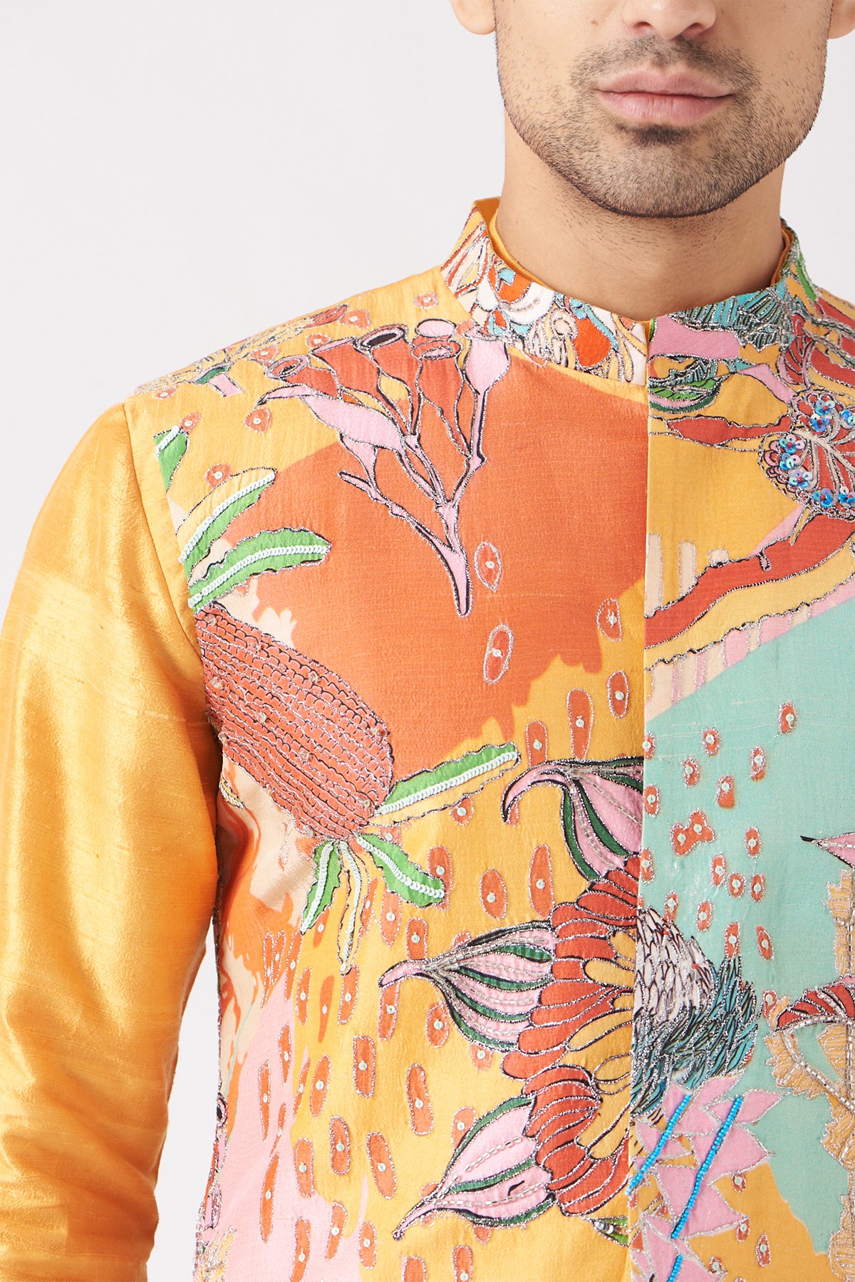 Close-up of front print and embellishments on yellow bundi and kurta