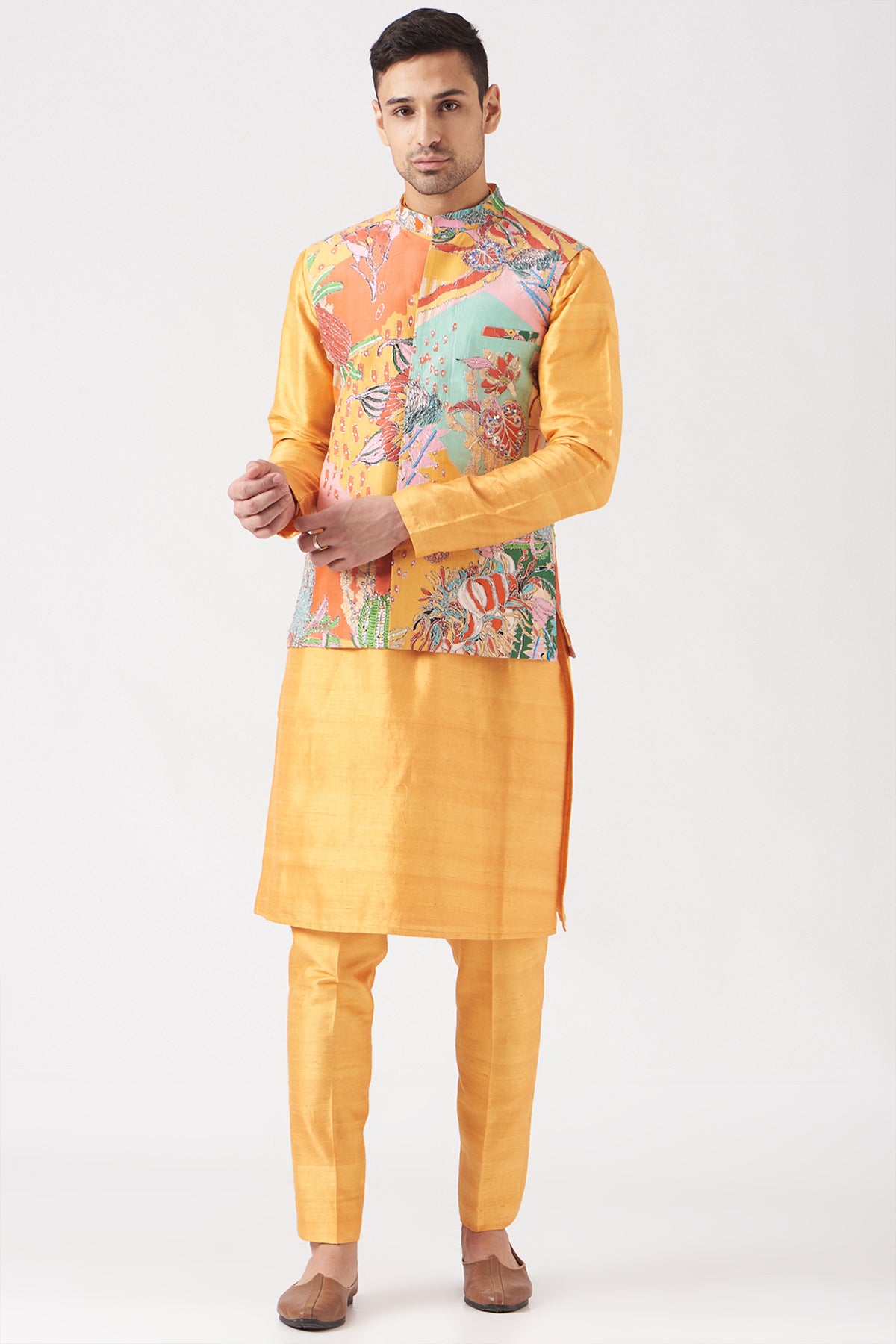 Front view of yellow pastiche raw silk printed and embellished bundi with yellow raw silk kurta and pant