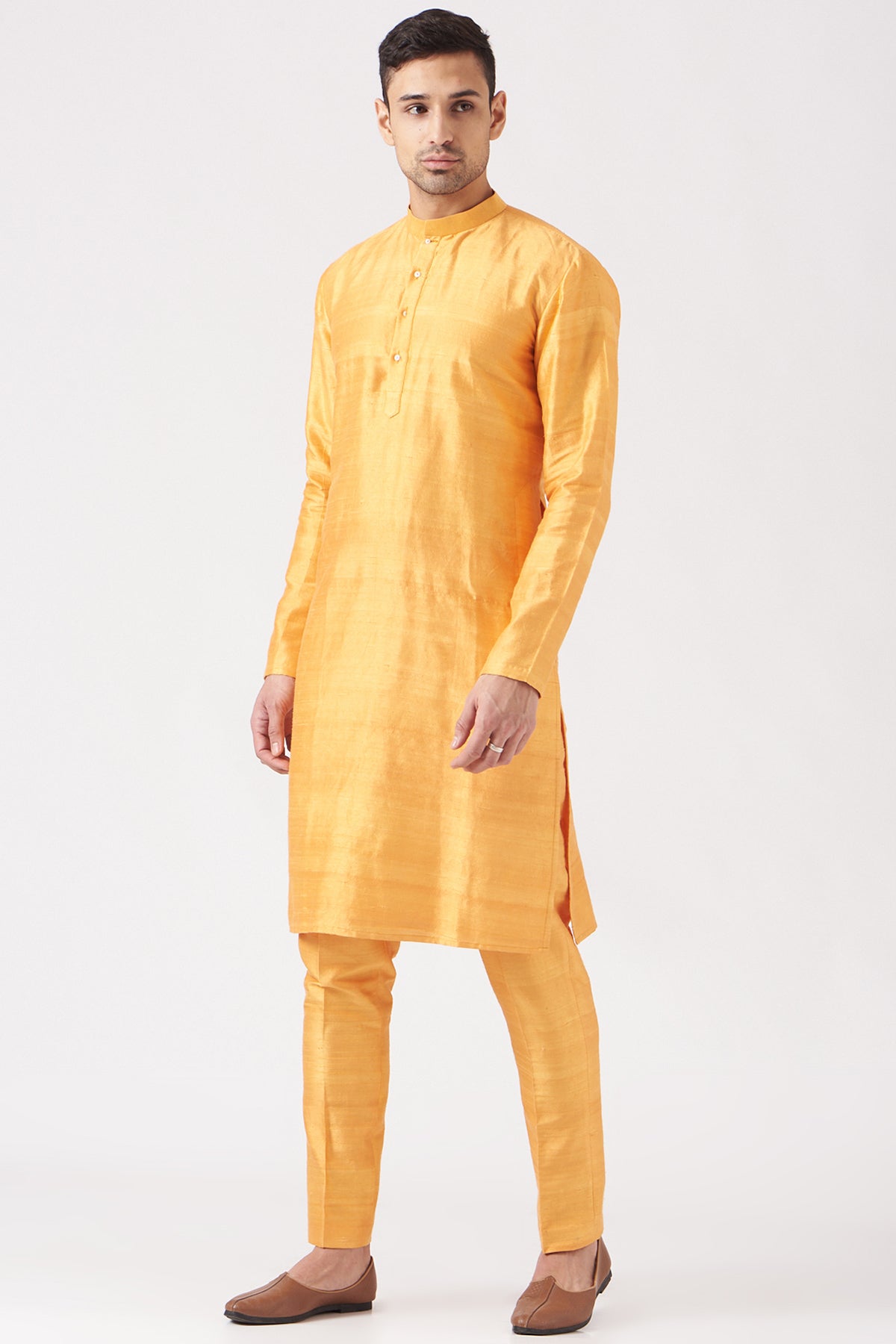 Left side view of yellow pastiche raw silk printed and embellished bundi with yellow raw silk kurta and pant