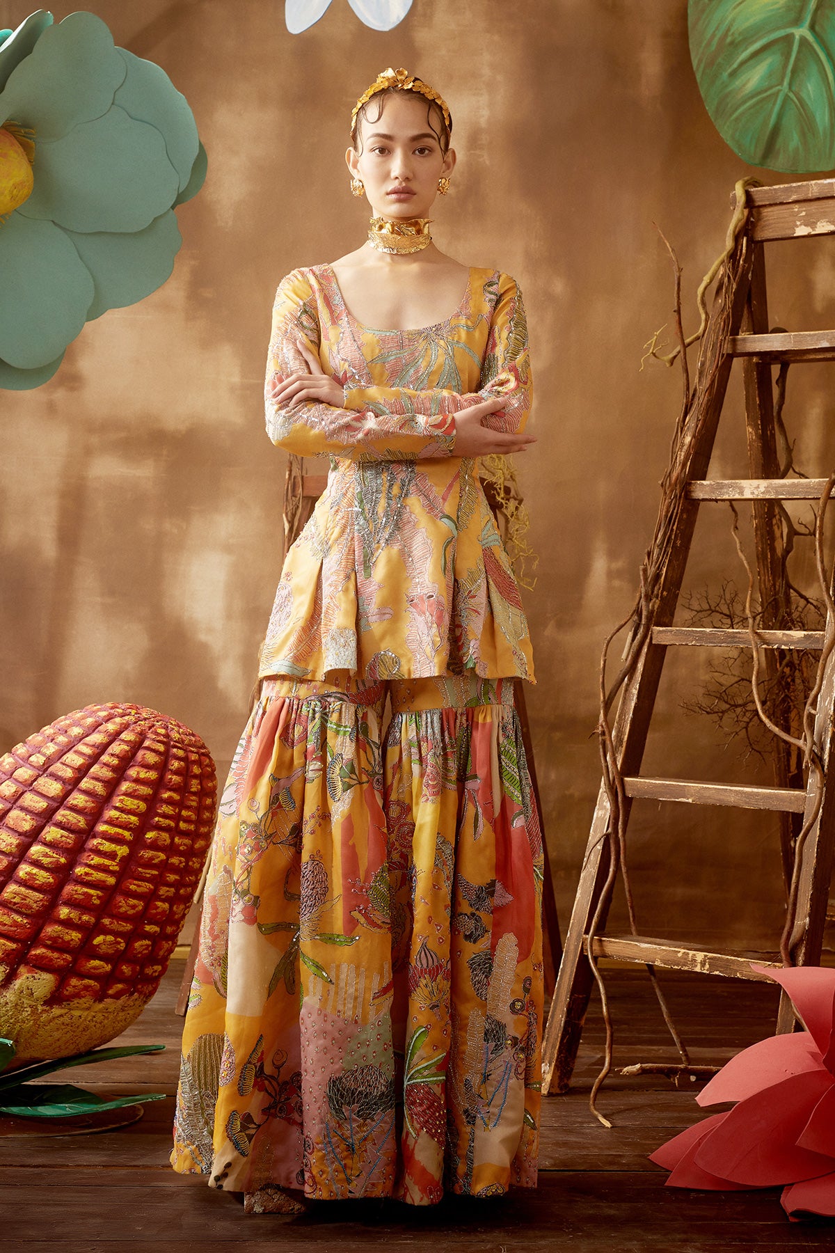 Front view of yellow pastiche printed and embellished satin organza sharara set with dupatta